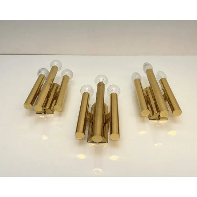 3 decorative wall sconces, probably produced in Germany, 1970s, in the style of Gaetano Sciolari. Each lamp has 3 E14...