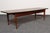 Vintage surfboard coffee table by Lane (ca. 1960s, USA). Composed of a walnut base with tapered legs flanking vertical...