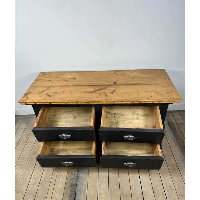 Low chest of drawers in solid pine, refinished with an elegant, slightly distressed black patina that gives it plenty of...