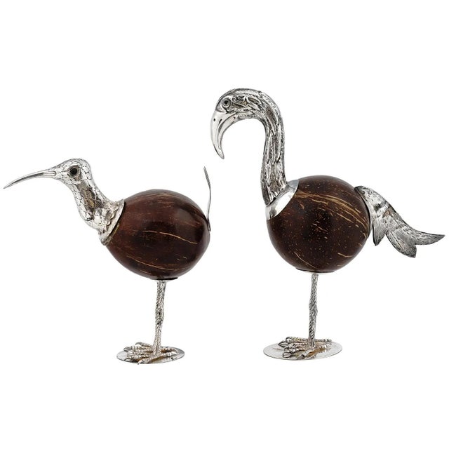 This pair of antique (late 19th to early 20th century) bird figurines are crafted from coconuts with silver legs,...