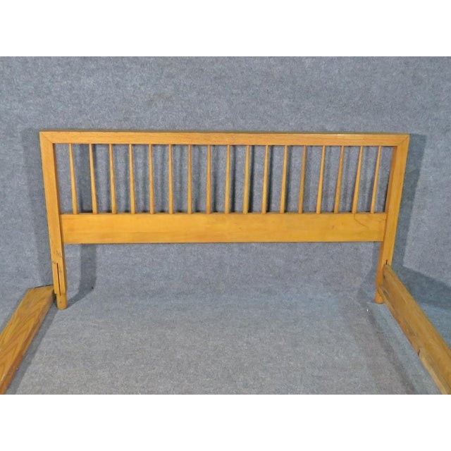 Beautiful vintage bed frame by Raymond Loewy, in a rich light walnut. Perfect for adding elegant and timeless Mid-Century...