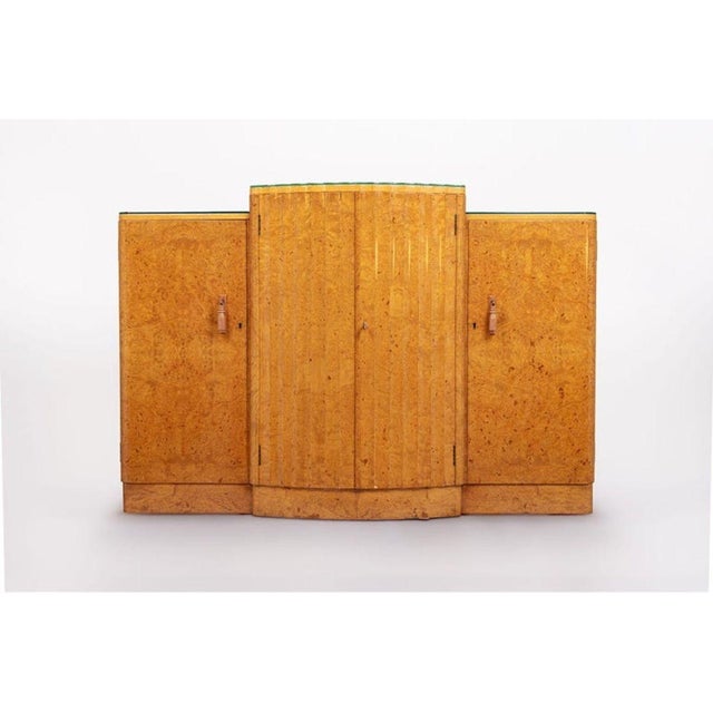 This exquisite English Art Deco maple wood bar cabinet or sideboard is attributed to Harry & Lou Epstein and is circa...
