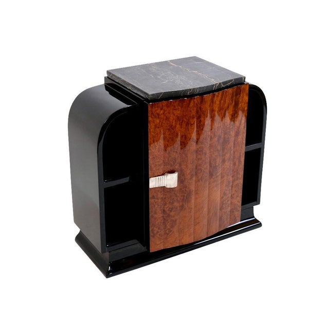 Pair of Art Deco nightstands France around 1930. Amboina wood and black lacquer, original marble tops. Inside there is a...