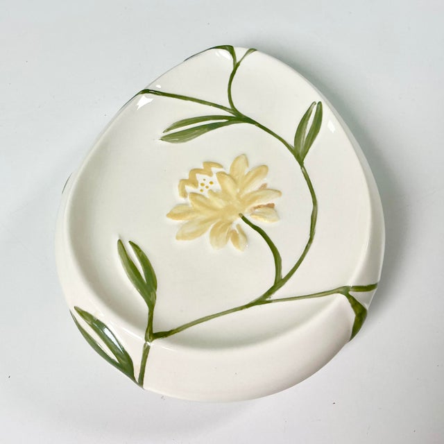 This is the lovely Penelope pattern from Croscill. It features an Art Nouveau style floral pattern with sage green stems...