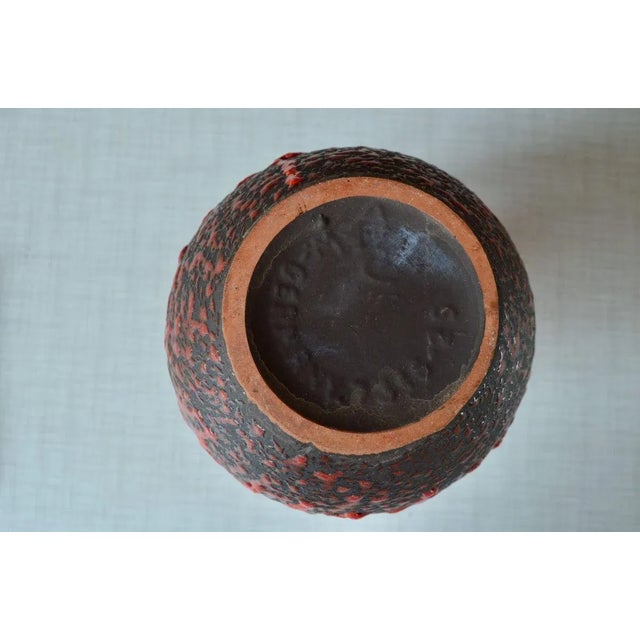 Obviously more decorative than usual, this ceramic pitcher is a pure fat lava production. The black enamel of the body of...