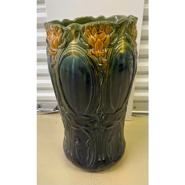 This is a beautiful example of Art Nouveau pottery, with flowing lines and botanical images. The color palette includes...