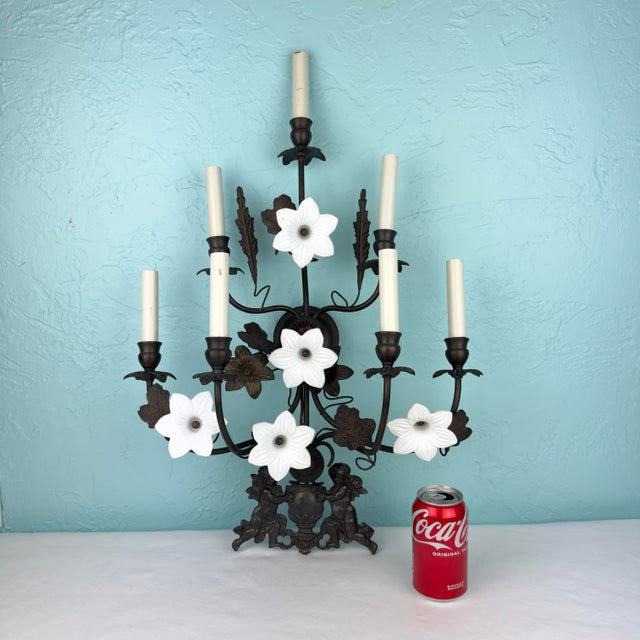 A striking and highly decorative mid‑century Hollywood Regency / Italianate wrought‑iron wall sconce featuring seven...