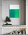 A soft, misted grey sky sits above a rich, saturated field of emerald green, the two halves blending together at a hazy...