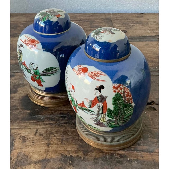 This elegant pair of vintage Asian ginger jars exemplifies the classic Famille Verte style set against a striking cobalt...