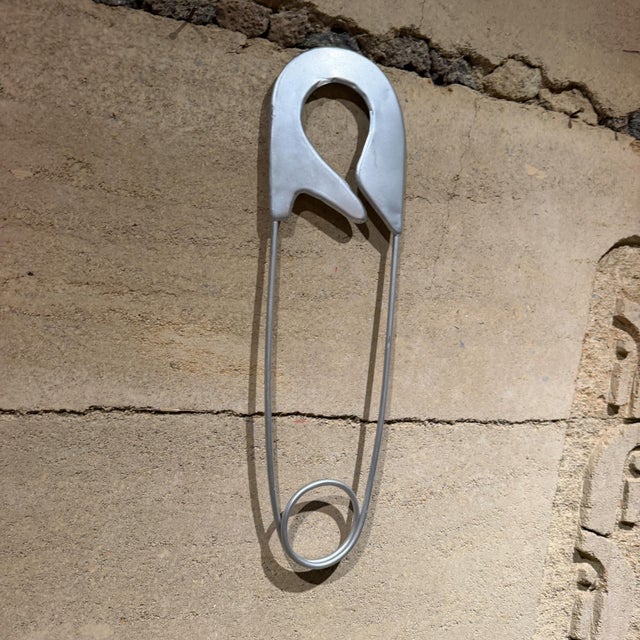 For your consideration, large wall sculpture , silver-colored metal safety pin is styled similarly to oversized fashion...