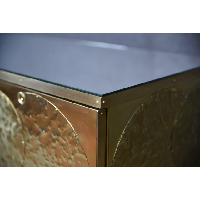 A modern brass and birch sideboard handcrafted in Italy, this beautiful piece features 8 spacious drawers and a refined...