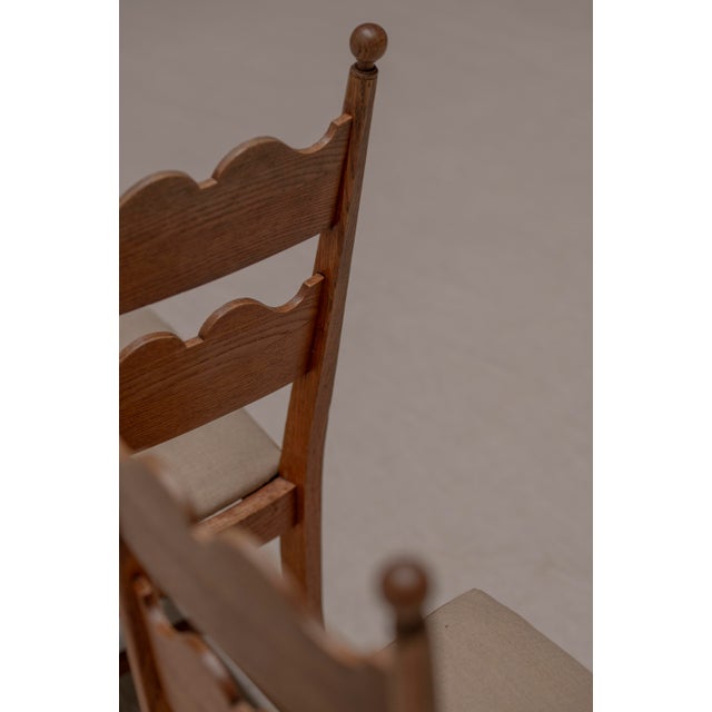 Charming set of two French mid-century side chairs influenced by the work of Charles Dudouyt, crafted in solid oak and...