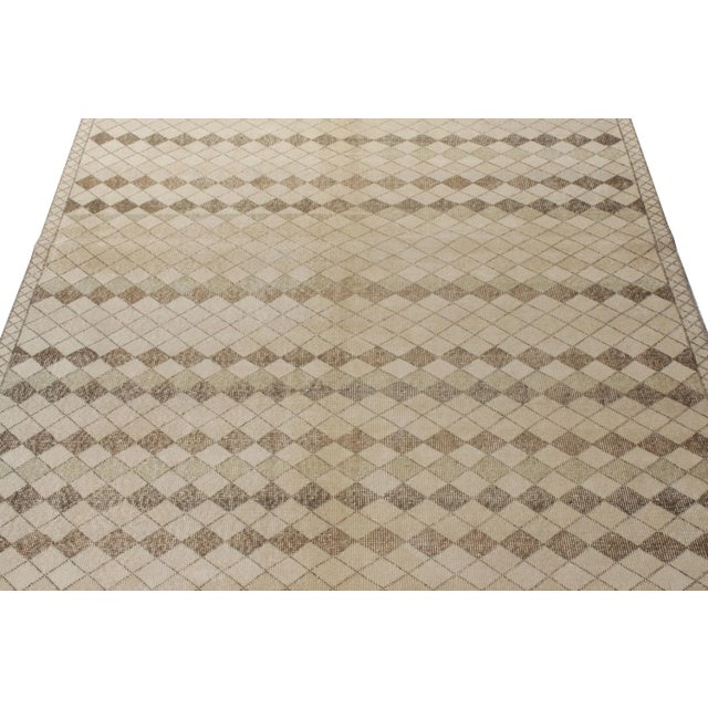 Hand-knotted in wool originating from Turkey circa 1960-1970, this vintage mid-century 5x9 Deco rug belongs to Rug &...