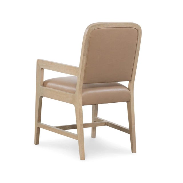 Cerused white oak dining chair with tan trapunto stitched leather seat back.