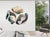 Three irregular ceramic slabs arranged together as a single wall piece, each carrying a different but related surface....