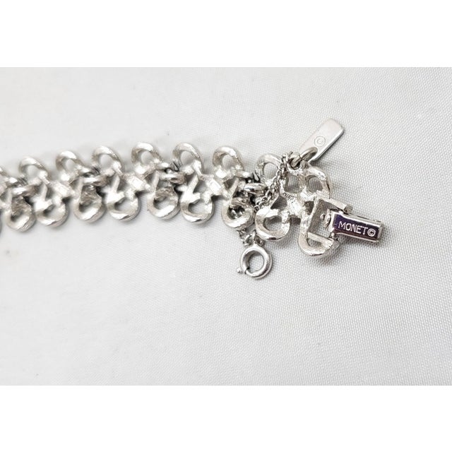 1975 rhodium plated S links with "nuggets" in between them articulated bracelet with fold over clasp and security chain....