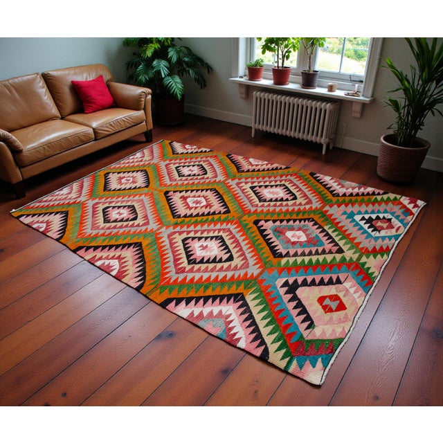 Woven in the Mediterranean region of Antalya during the 1970s, this vintage flatweave kilim reflects the rich, nomadic...