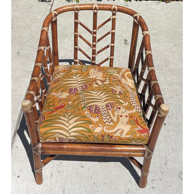 Super cool vintage chair by luxury brand McGuire of San Francisco. The chair features a warm brown rattan frame in a...