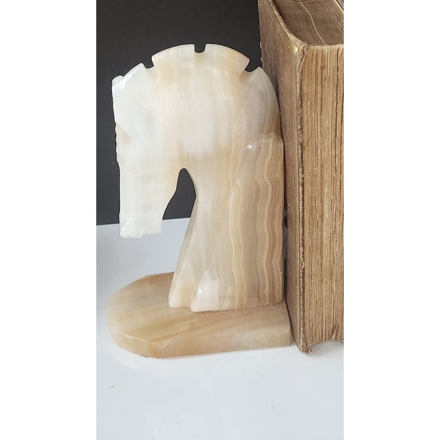 A striking pair of mid-century carved horse head bookends crafted from richly banded Mexican onyx. The sculptural design...
