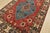 A tribal Caucasian Kazak rug hand-knotted with fine wool on a cotton foundation. This oriental rug features a central...