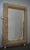 A sturdy gold-colored frame captures the eye of the observer, leaving him enchanted: it is a wall mirror in gold-colored...