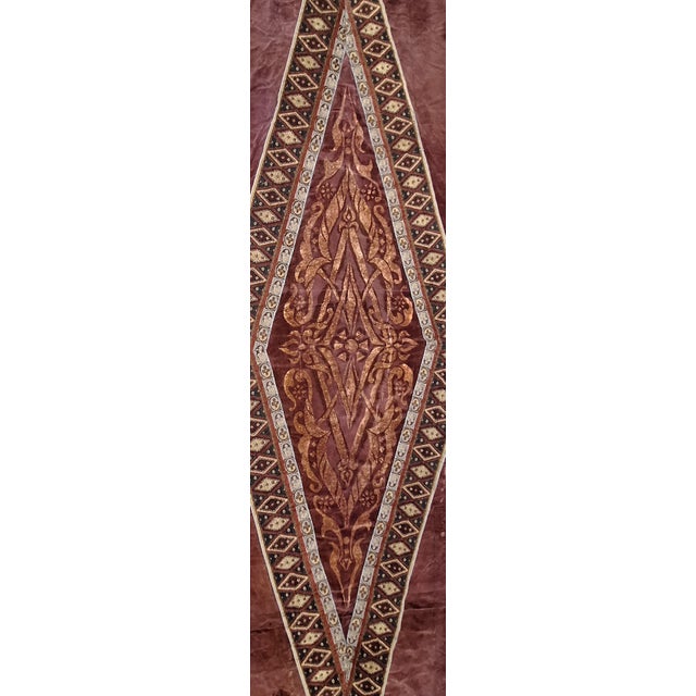 Marron velvet fabric geometric design with rubber fringes, and a cotton backing . The fabric was used in the play Master...