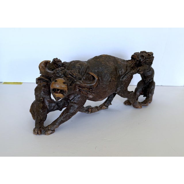 Large hand carved African Ironwood sculpture depicting a male and female lion attacking a Cape Buffalo. Amazing detail....