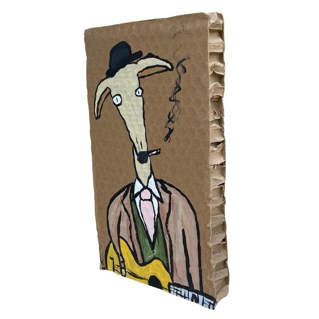 Folk art painting by Kentucky artist Morgan Evans of a dog in a suit playing guitar. Painted on thick cardboard. He’s very...