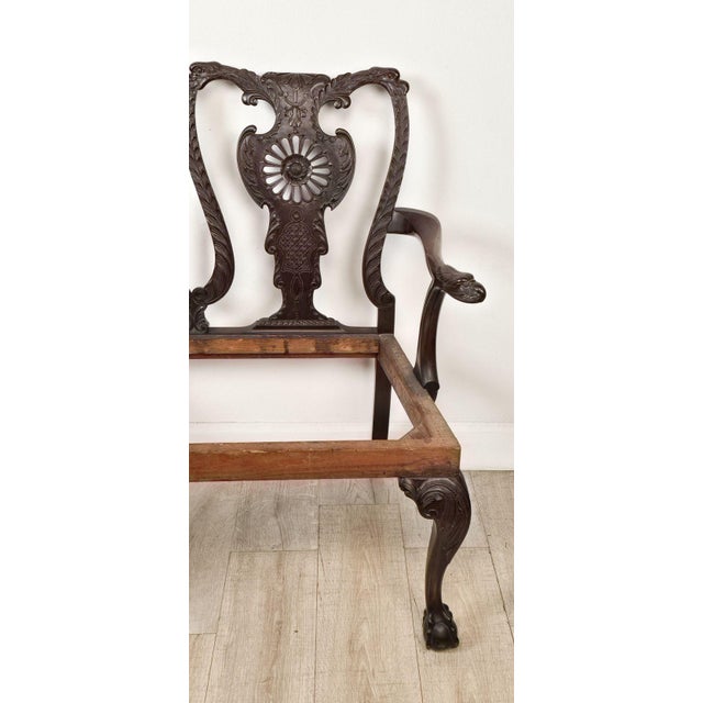 A 19th-century English or Irish mahogany Chippendale settee. Seat height 17.5".