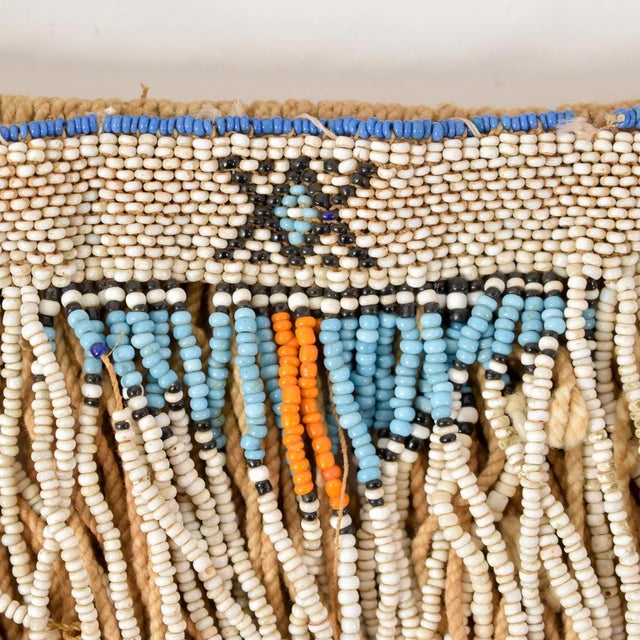 The Xhosa beaded apron is a richly symbolic artifact that embodies the cultural identity, aesthetic values, and social...