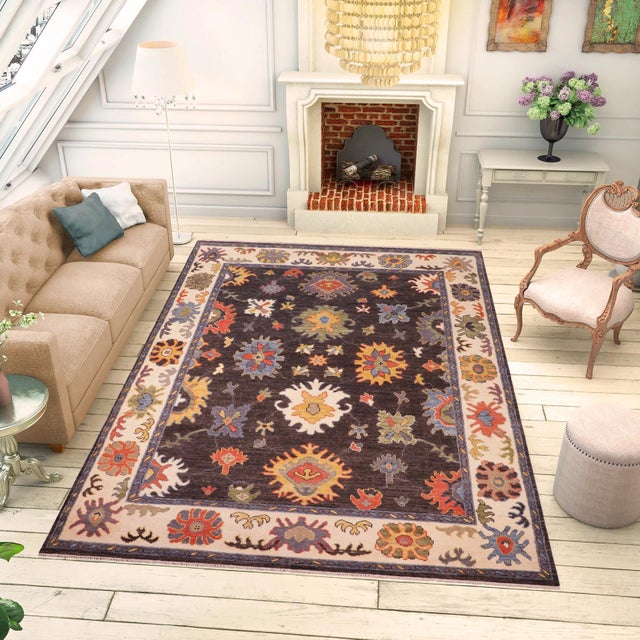 Enhance the ambiance of your home with this magnificent Persian-influenced Turkish hand-knotted rug made by skilled...