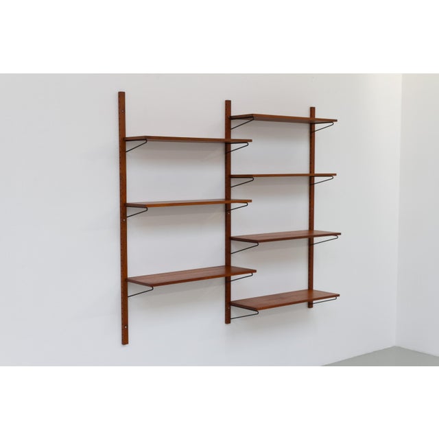 Vintage Danish wall mounted teak shelving system, 1960s. Floating Scandinavian Mid-Century Modern two bay wall unit in...