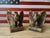 A striking pair of Brass American Bald Eagle Bookends with outstretched wings perched on a branch with vining oak leaves....