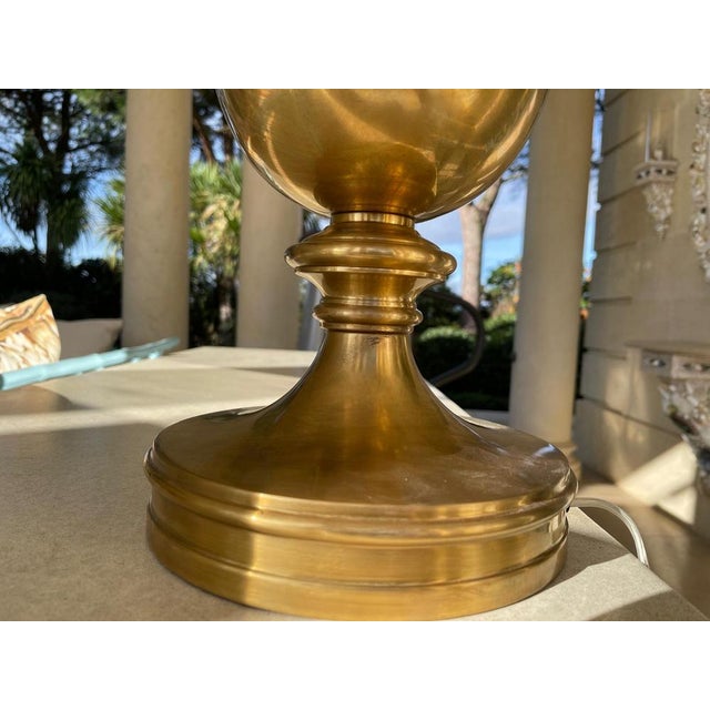 A refined pair of classical decorative table lamps executed in an Antique Burnished Brass finish, distinguished by an...