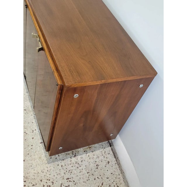 This Bernhardt Flair Milo Baughman style sideboard is constructed of a walnut case with rosewood doors and Mirrored Chrome...