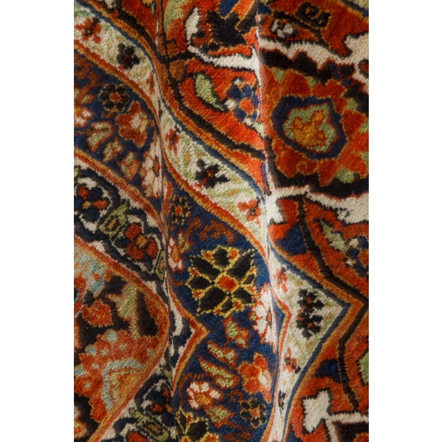This circa-1920 antique Mashad Persian rug features a striking all-over design of floral abstractions and interlocking...