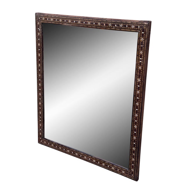 An exquisite mid 20th century Syrian mirror showcasing traditional mosaic inlay craftsmanship. The wooden frame is...