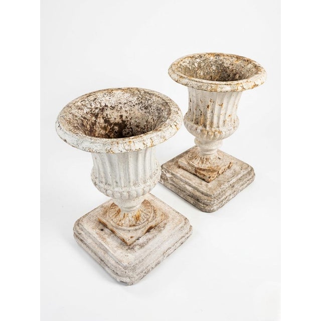 Enhance a garden or entryway with this striking pair of vintage cast iron planters. These classic Campana-style urns...