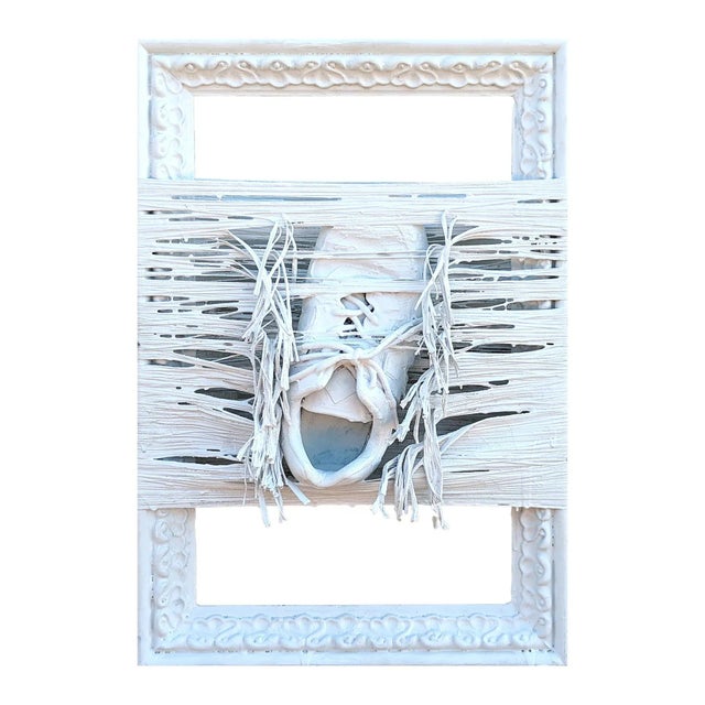 White abstract found object painting by Houston, TX artist Tra' Slaughter. The painting features a shoe suspended with...