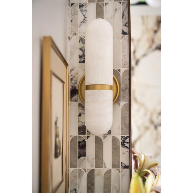 Infuse modern elegance into your home with the Salon Sconce. This deco-inspired fixture features rounded globes made of...