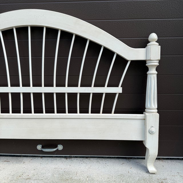 An early 21st century Ethan Allen Country French / Maison collection wheatback full size footboard in distressed beige....