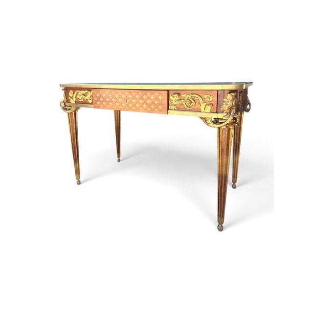 A fine late 19th-century French Louis XVI style bureau plat attributed to Maison Beurdeley. The three-drawer desk features...
