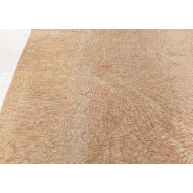Steeped in centuries-old tradition and unmistakable artisanal craftsmanship, this 19th-century Turkish Oushak rug, woven...