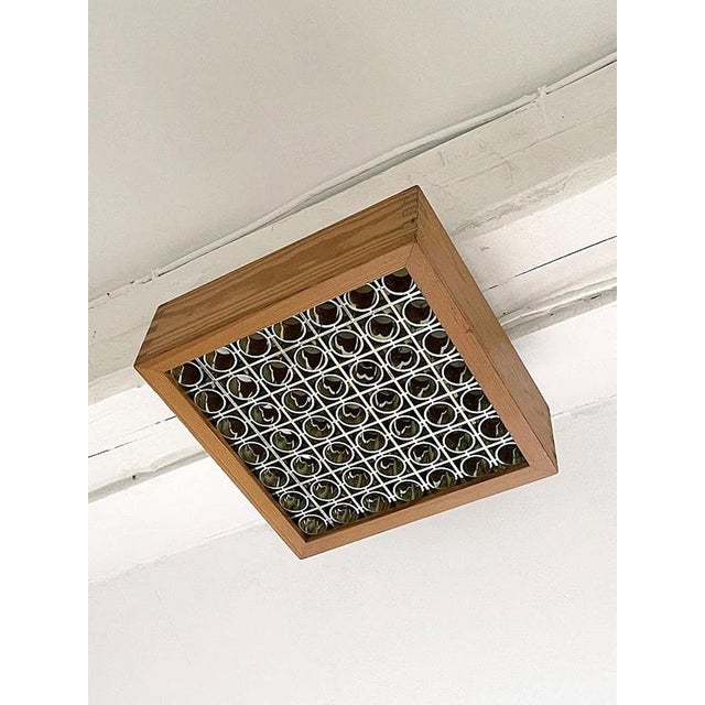 This square ceiling light attributed to Alda, Sweden, is a striking example of 1970s Scandinavian lighting design, where...