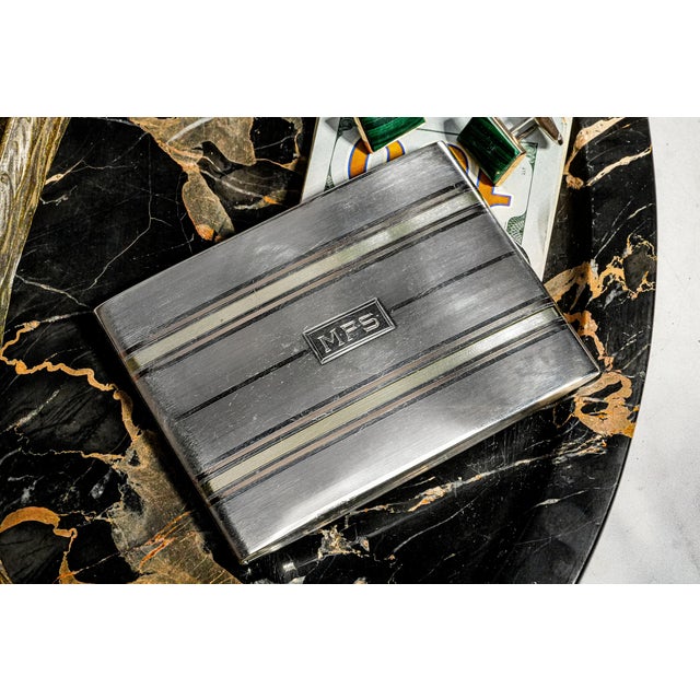 A particularly handsome example of 1920s Art Deco luxury, this antique cigarette case is crafted in sterling silver and...