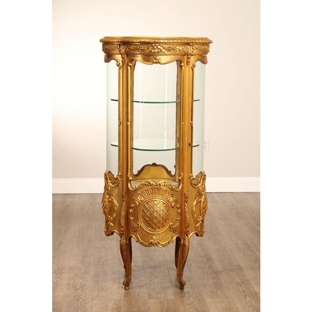 High Quality Rococo Style Giltwood Curio Vitrine Cabinet With A Shaped Glass Front.