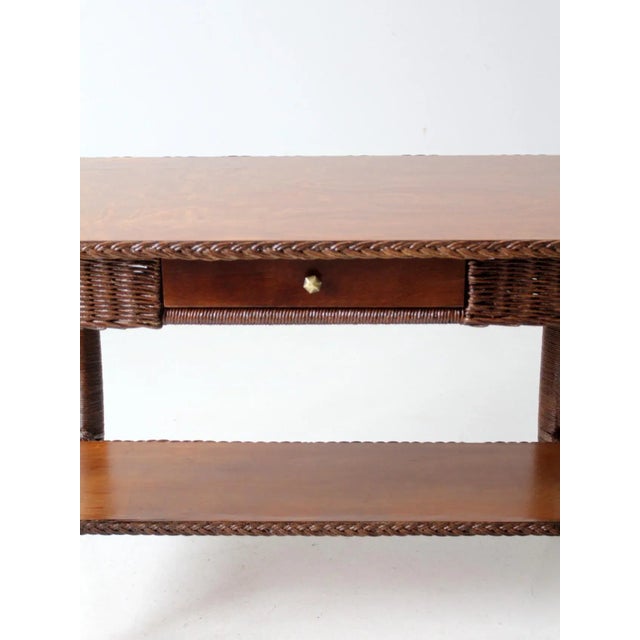 This beautiful antique table, dating to the early 20th century, combines the natural beauty of woven willow with the...