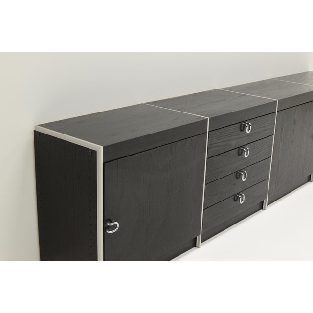 Large black and aluminum sideboard by Interlübke, 1980s Germany. Black wood with aluminum dividers between the cabinets...