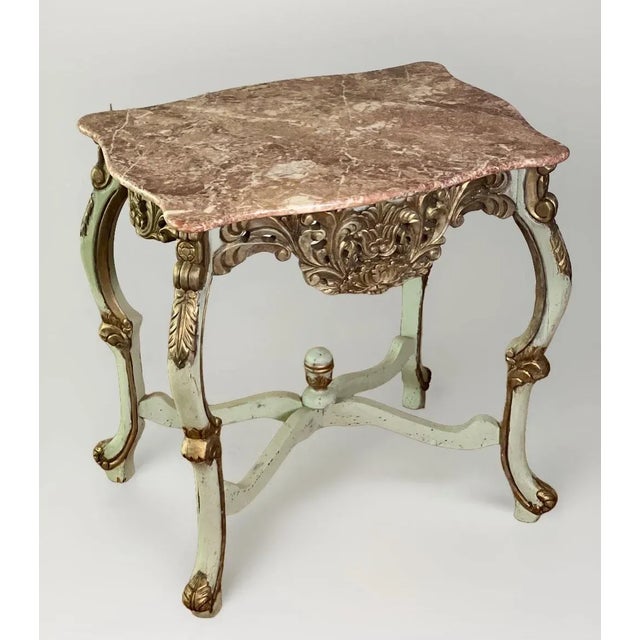 Country French center table or console carved and painted in pale sage green with. rouge marble top and gilt wood accents,...