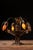 Cast metal boudoir table lamp designed in the Art Nouveau taste with four gracefully arched arms supporting pink slag...